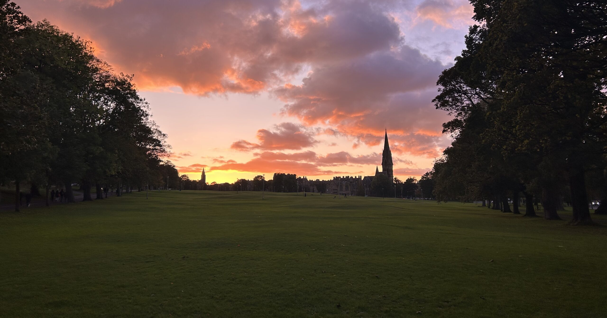 Students gathered on the Meadows at sunset